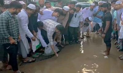 সড়কের গর্তে জমে থাকা পানিতে মাছ ছাড়েন হাসনাত আবদুল্লাহ। ছবি- সংগৃহীত