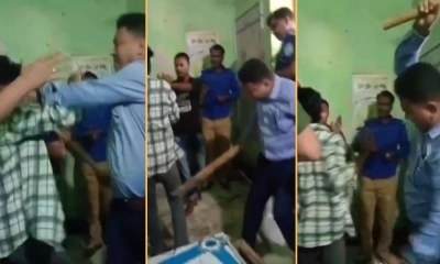 শিশুকে লাঠি দিয়ে পেটাচ্ছেন ইউএনও। ছবি- সংগৃহীত