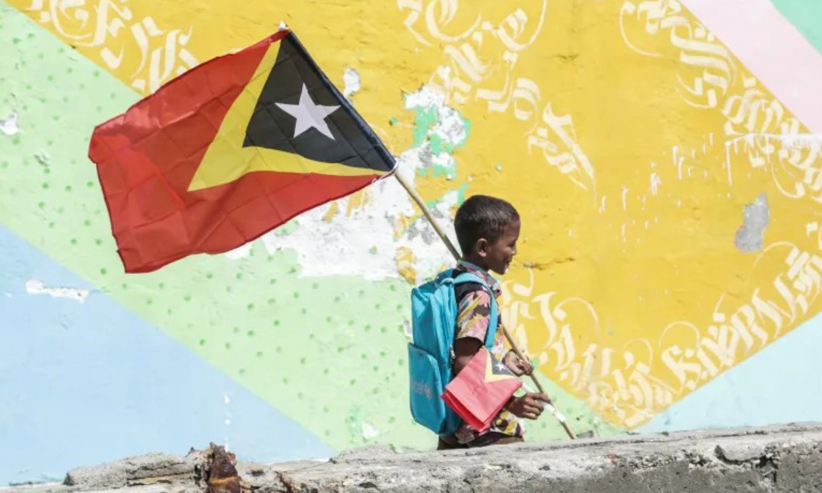 পতাকা হাতে পূর্ব তিমুরের শিশু। ছবি- সংগৃহীত